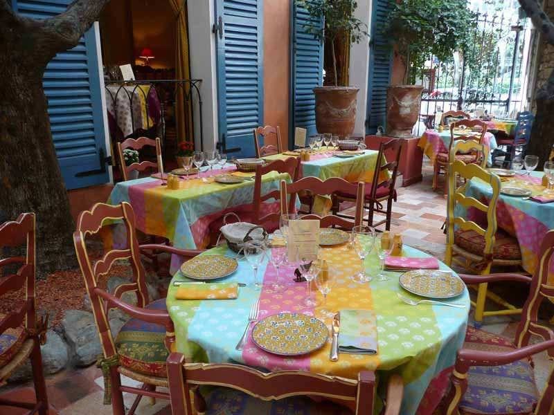 The terrace of the restaurant Le Sud, colourful Provençal tables